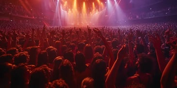 Massive crowd at a concert with raised hands.