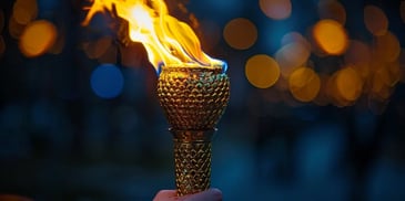 Hand holding a lit torch at night.