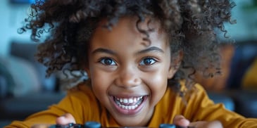 Excited child with curly hair playing game.