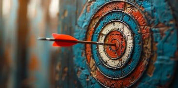 Close-up of an arrow hitting the bullseye on a weathered archery target.