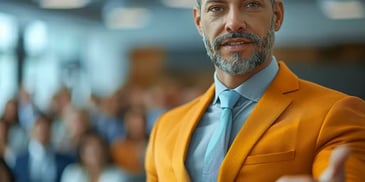 Confident man in orange blazer presenting.